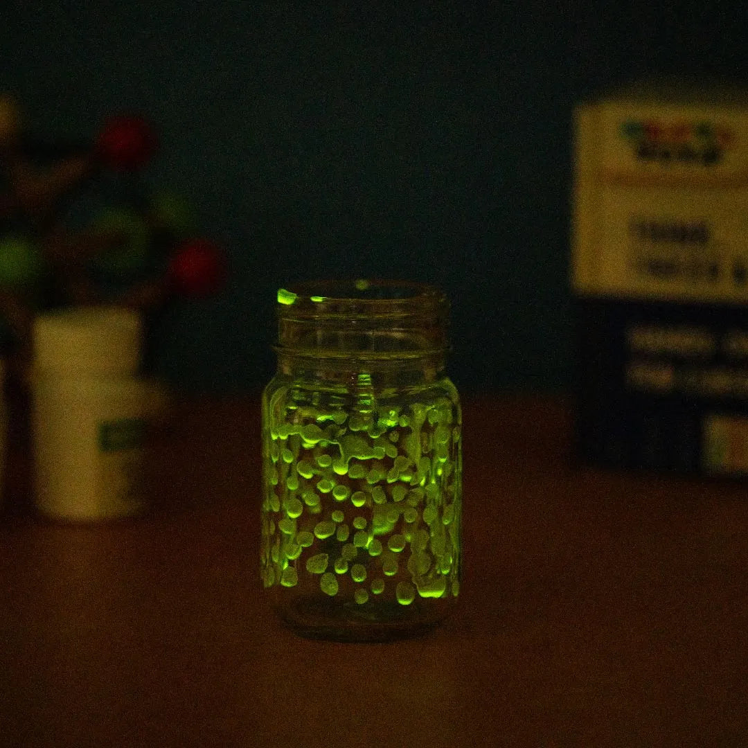 NESTA TOYS - Glow in dark toy, glow puzzle kids, glow activity kit, glow science toy, glow learning toy, glow educational toy, kids glow toy, glow toy set, fun learning toy, educational glow toy, kids activity toy Glass jar filled with glowing green beads shining in the dark during a glow in the dark science experiment for kids