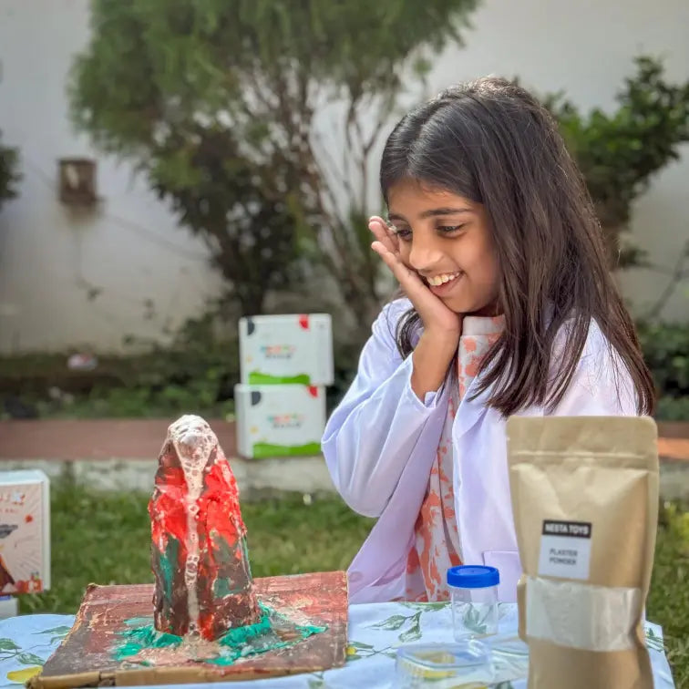 NESTA TOYS Child building and erupting a volcano model using the Nesta Toys kit