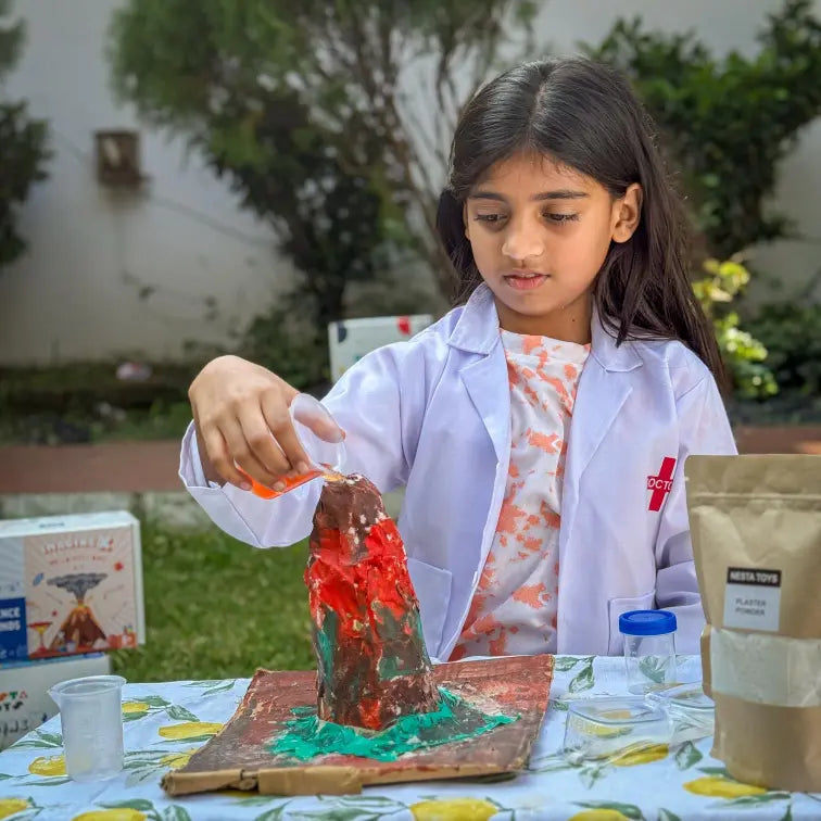 NESTA TOYS Child building and erupting a volcano model using the Nesta Toys kit