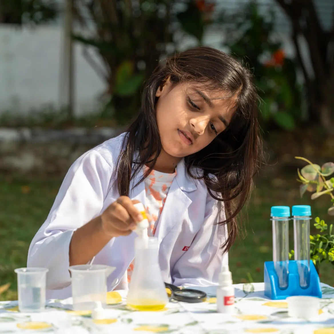 NESTA TOYS Child performing hands-on experiments with the Nesta Toys Junior Chemistry Lab Kit