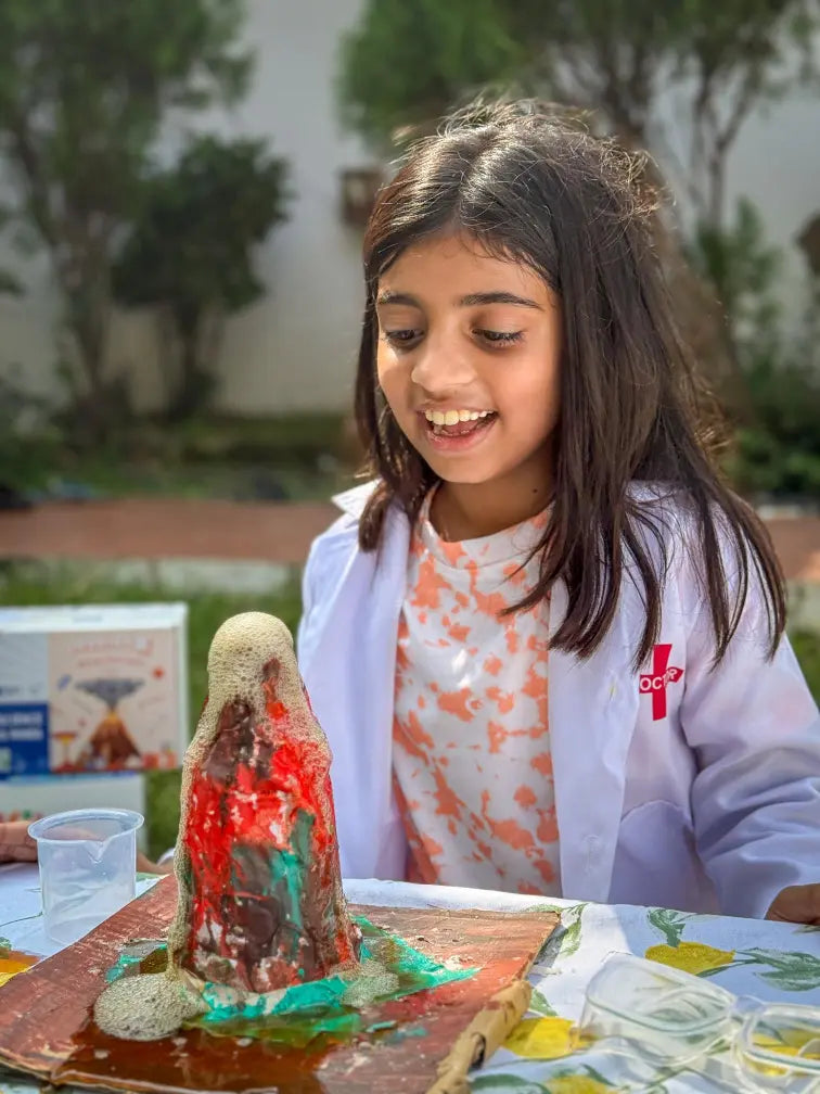 Child conducting an eruption with the Ultimate Volcano Kit from Nesta Toys