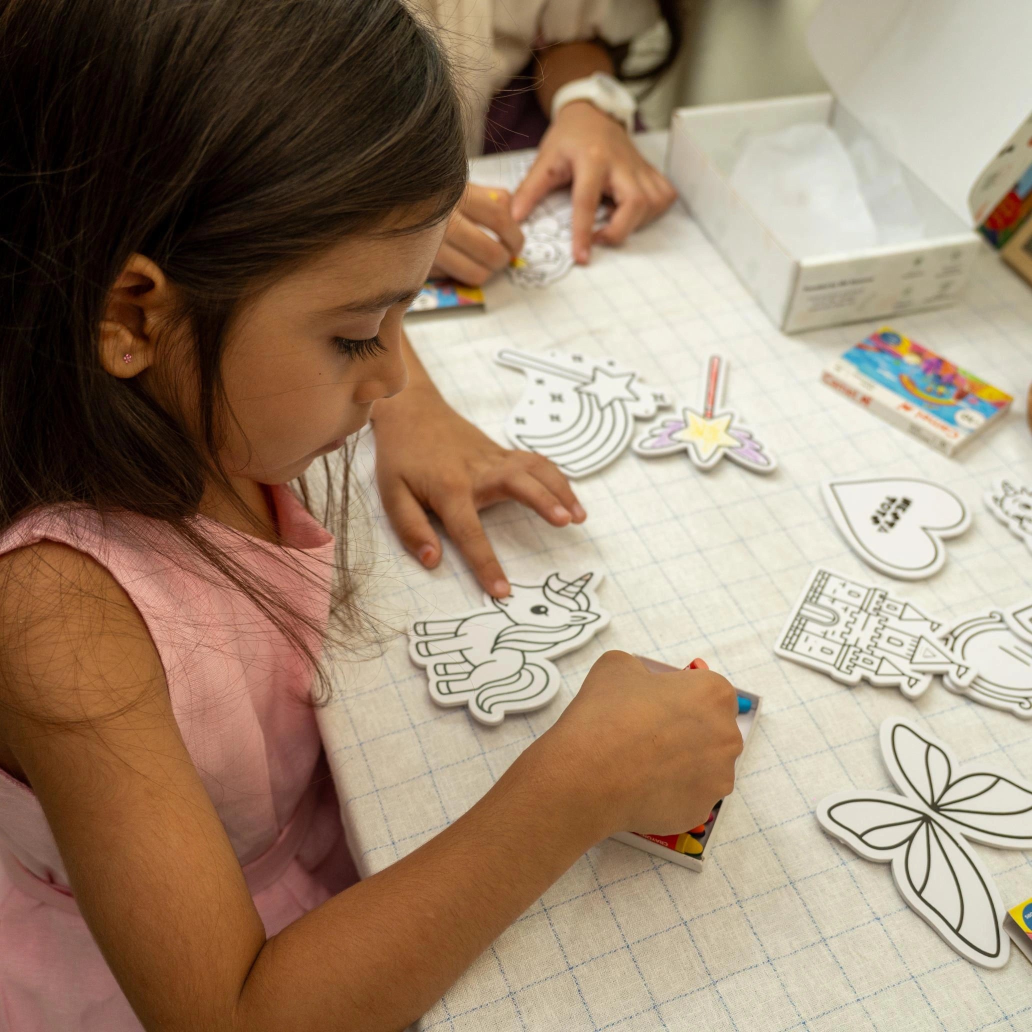 Kid playing with DIY unicorn fridge magnets craft kit by Nesta Toys