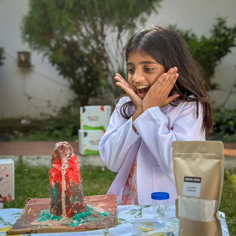 Child conducting an eruption with the Ultimate Volcano Kit from Nesta Toys