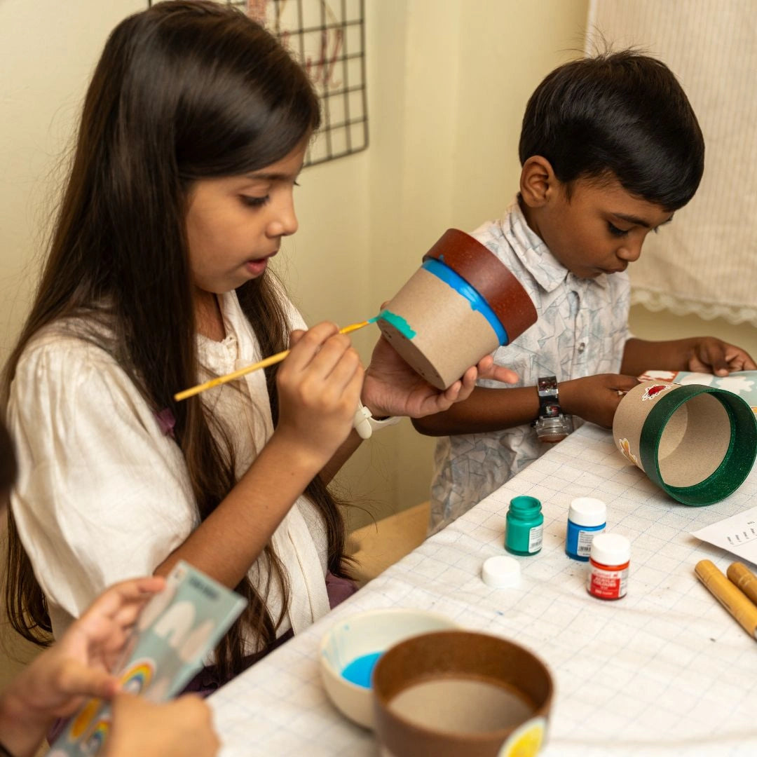 Kids decorating flower and herb pots with the DIY Gardening Kit