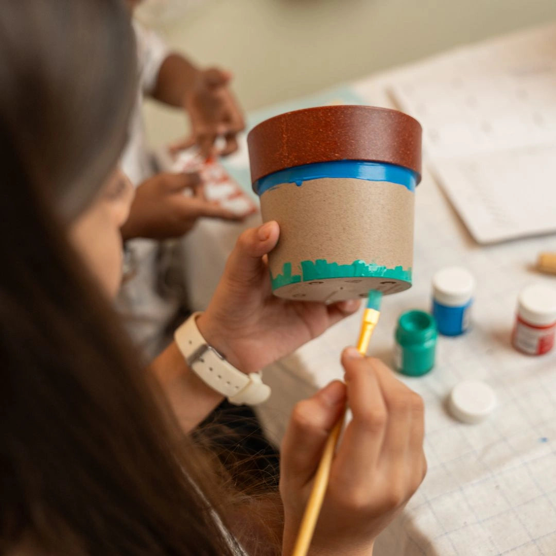 Child painting pots for STEM plant science activities