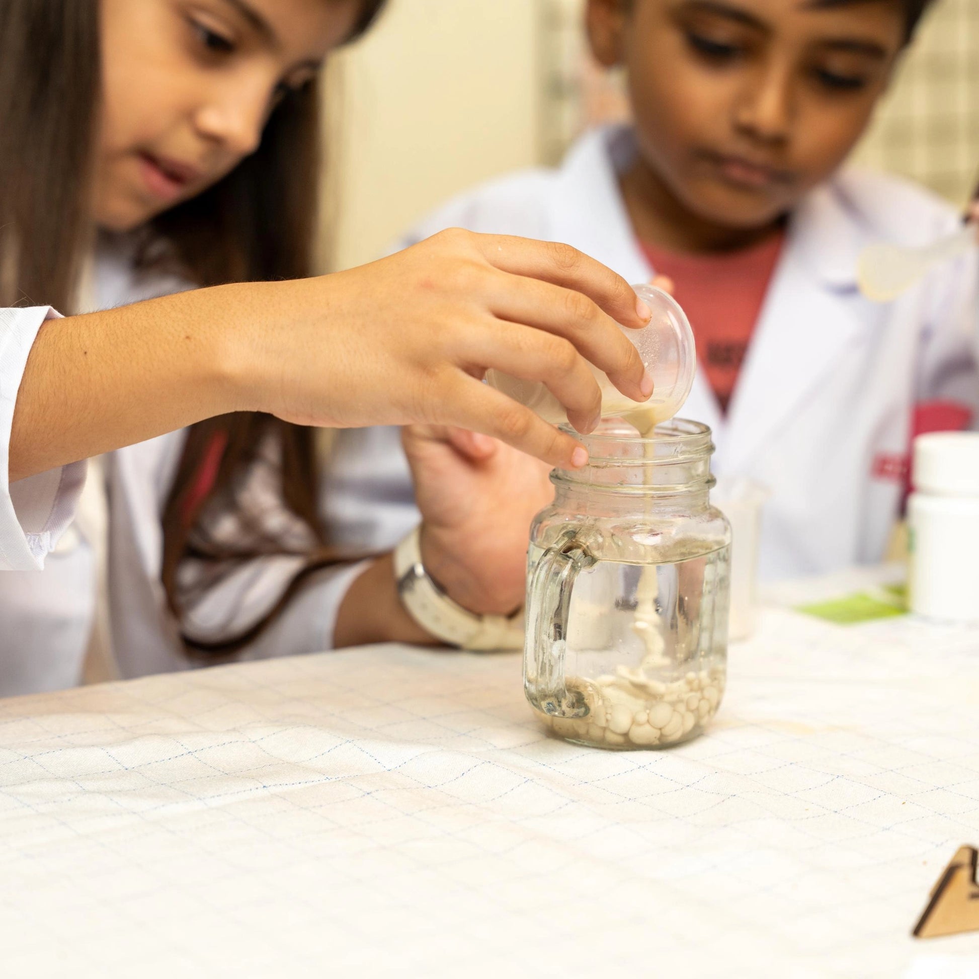 Kids exploring science and chemistry using the Glow in The Dark Lab Kit